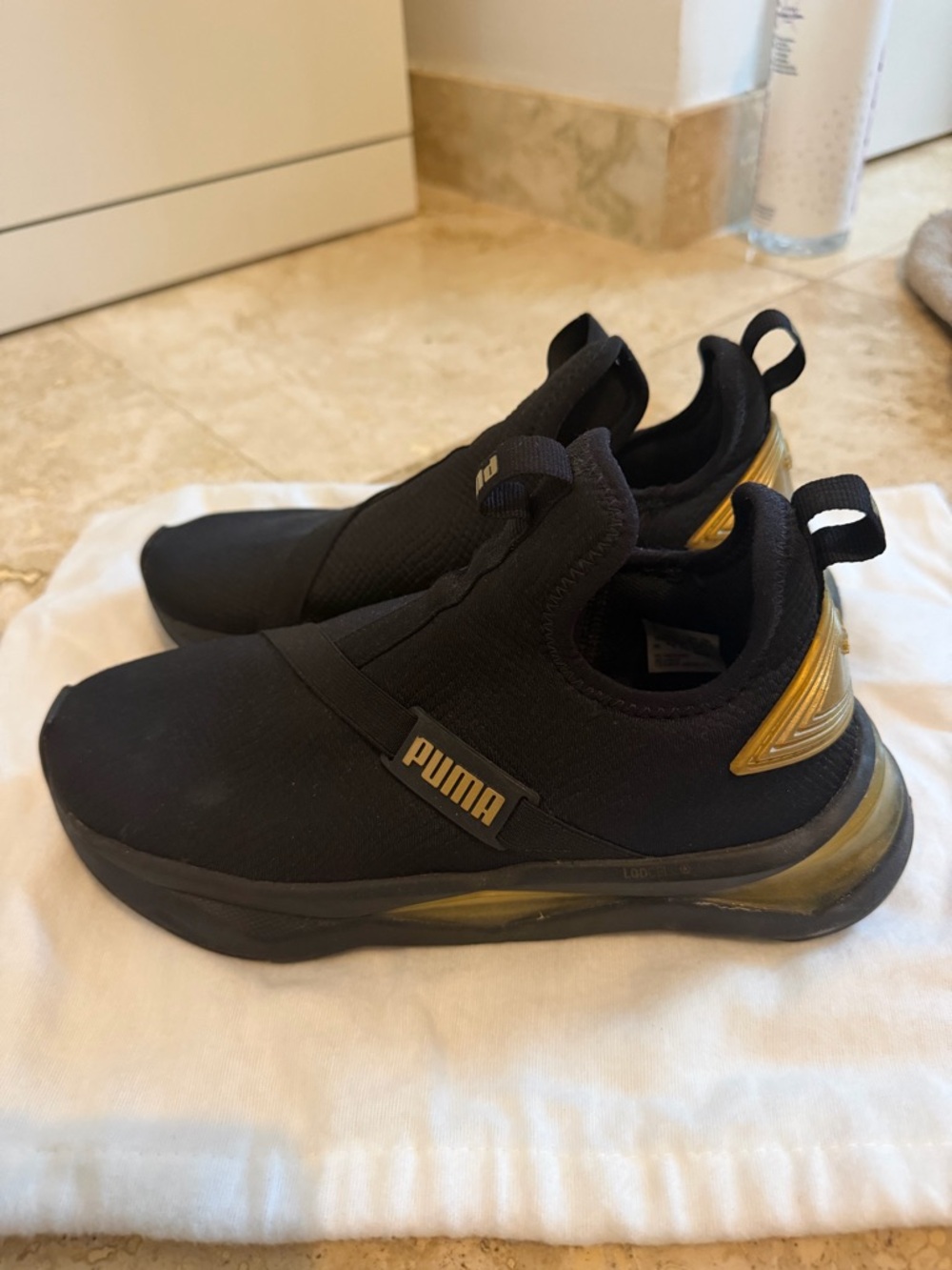 Puma Woman’s Black and Gold Slip-On Sneakers